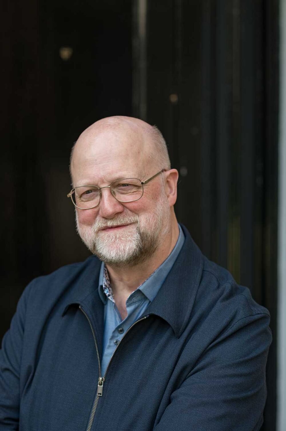 Author portrait against a black backdrop.