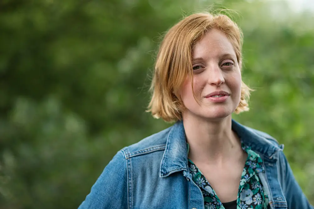 An outdoor professional portrait against a softly blurred background