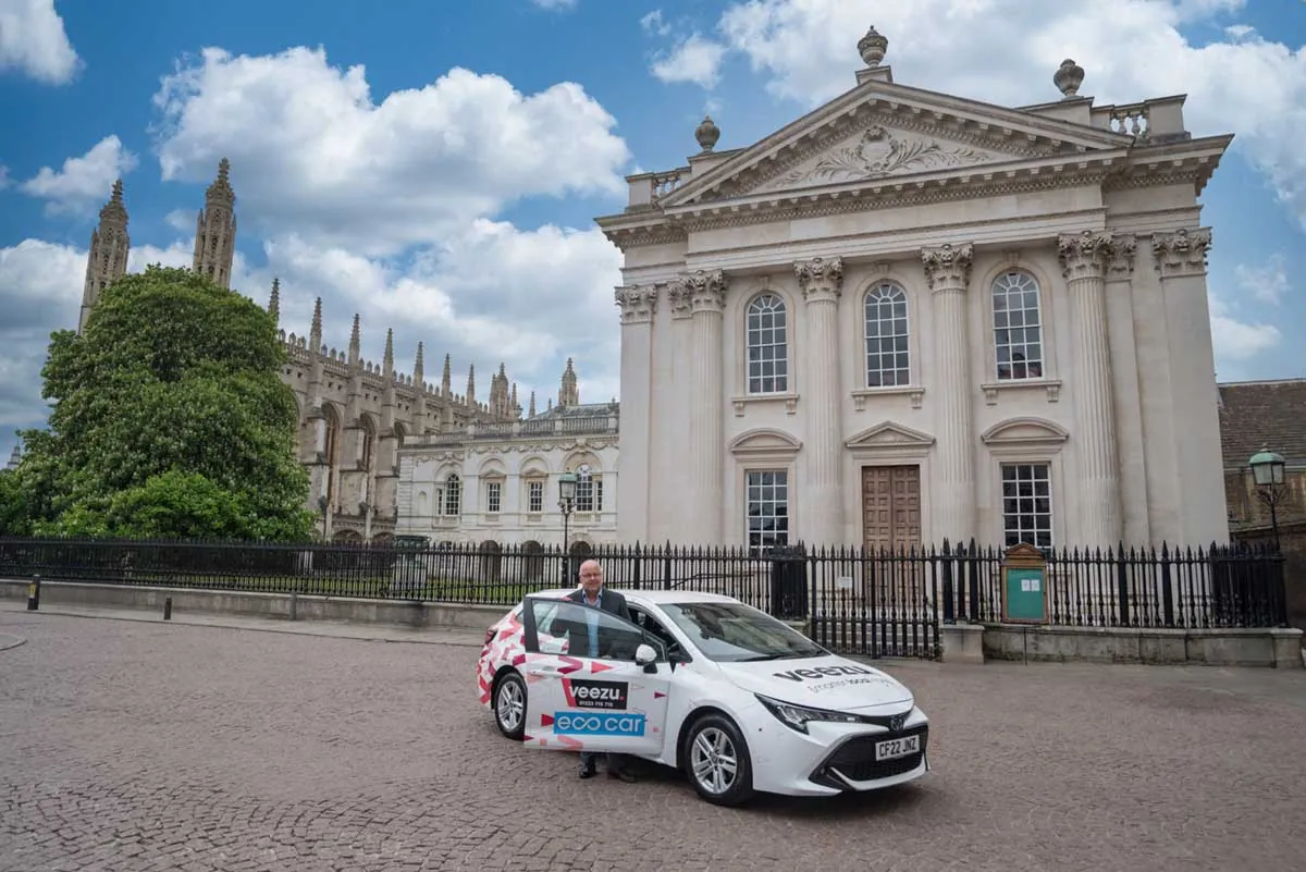 A Veezu taxi parked in front of the Senate House in Cambridge
