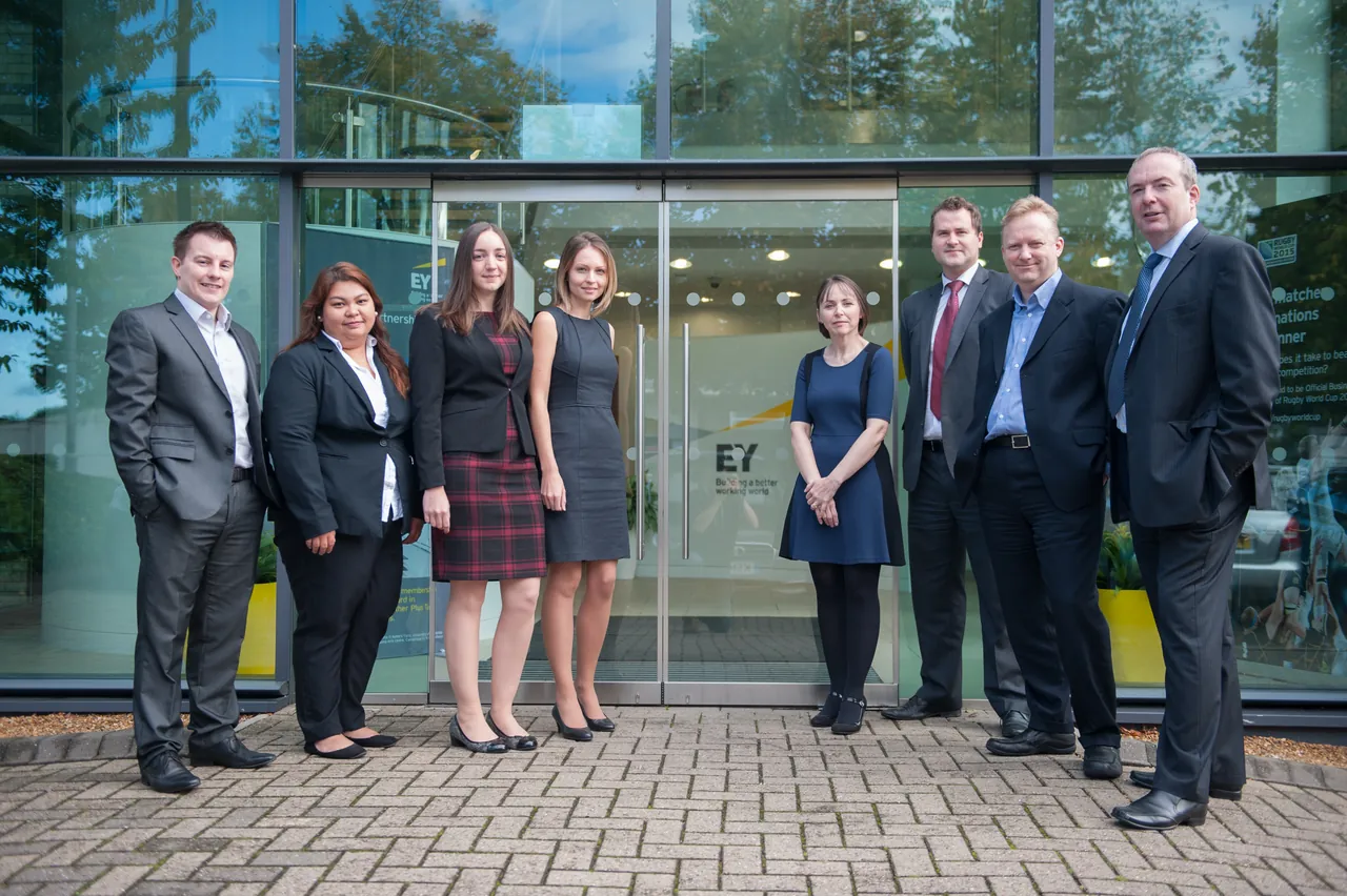 An EY team standing outside their Cambridge office entrance