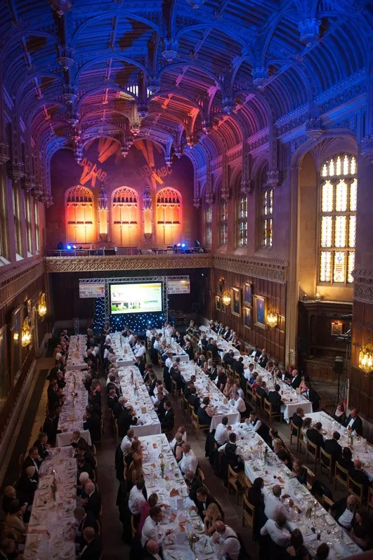 A formal dinner laid out in King’s College dining hall, seen from above