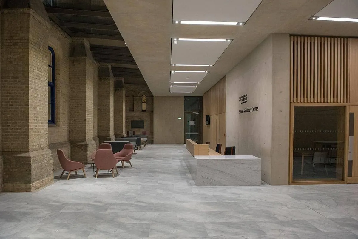 A converted Victorian corridor in a Cambridge business school with modern seating and a reception desk