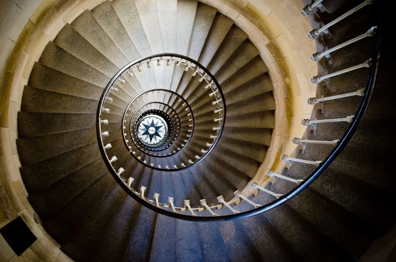 A spiral staircase photographed from below
