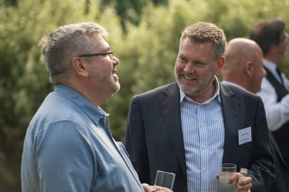 Professional business networking event in outdoor setting.