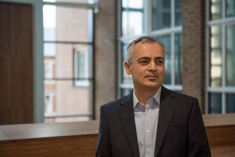 Professional corporate photographer portrait in modern office environment.