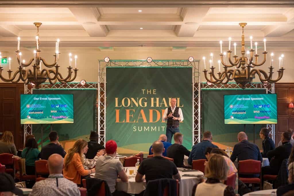 High-quality corporate event photography at The Long Hall Leadership Summit in a grand ballroom setting.